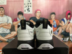 Rear view of white and black Jordan sneakers showing heel branding, pull tabs and patterned outsole details.
