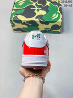 Rear view of a sneaker showing a red heel panel and STA branding