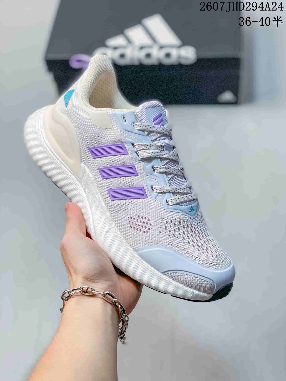 Angled side view showing the white mesh upper, lilac stripes, light blue details, and thick sculpted sole.