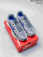Pair of gray and blue Nike P-6000 sneakers displayed on a red shoebox.