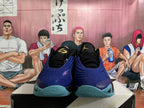 Front view of black and blue Jordan basketball shoes with aqua outsoles.