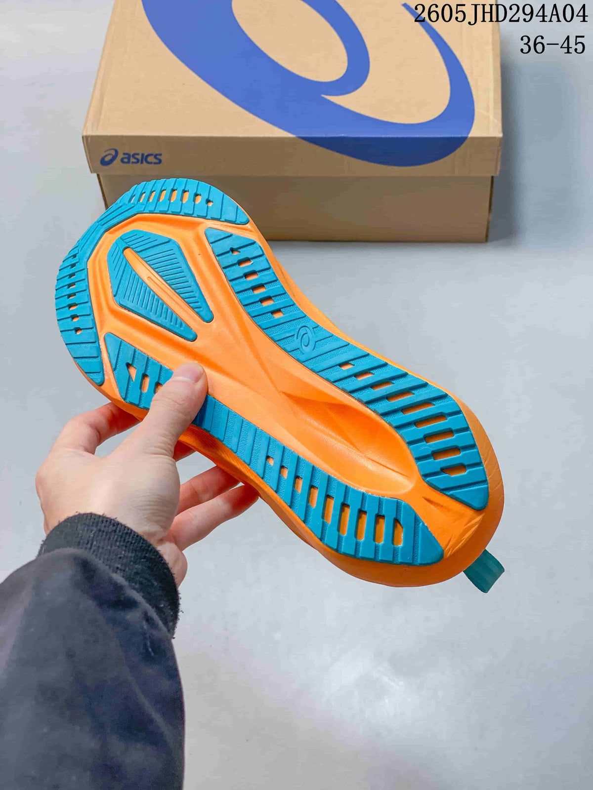 Underside of the running shoe showing a teal and orange outsole