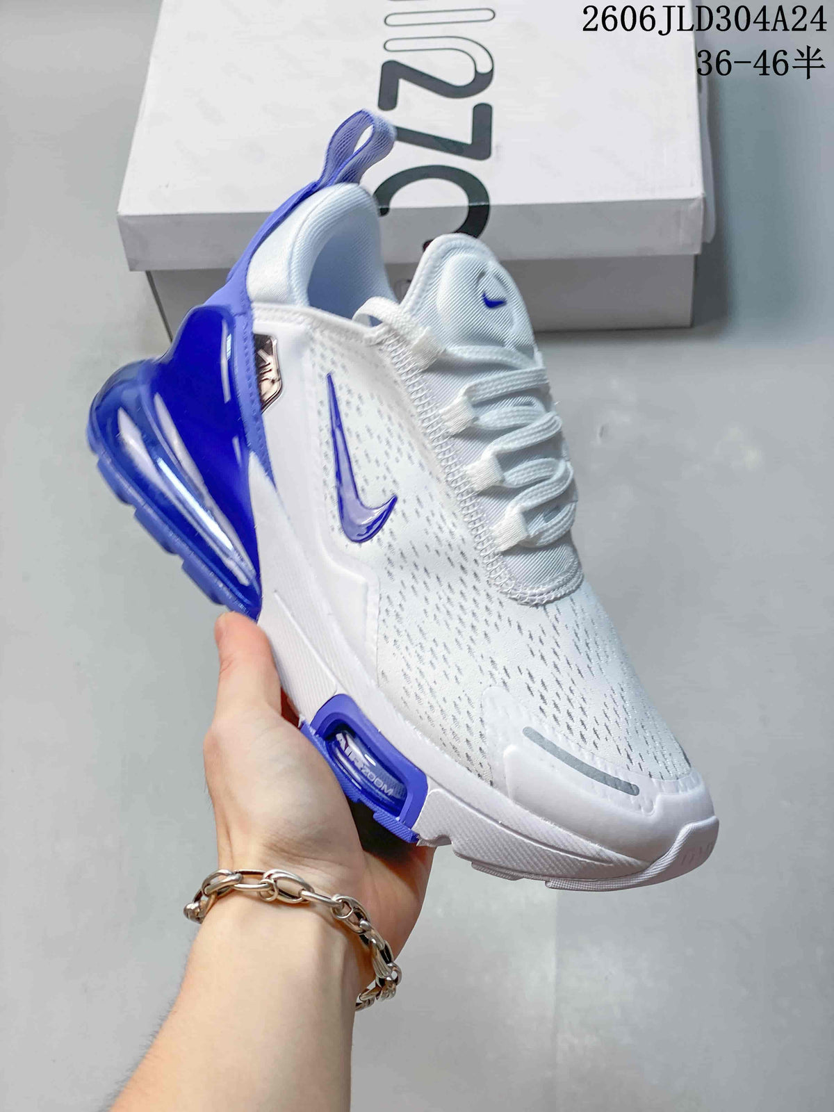 Angled view of a white and blue Nike Air Max 270 sneaker with lace-up closure.