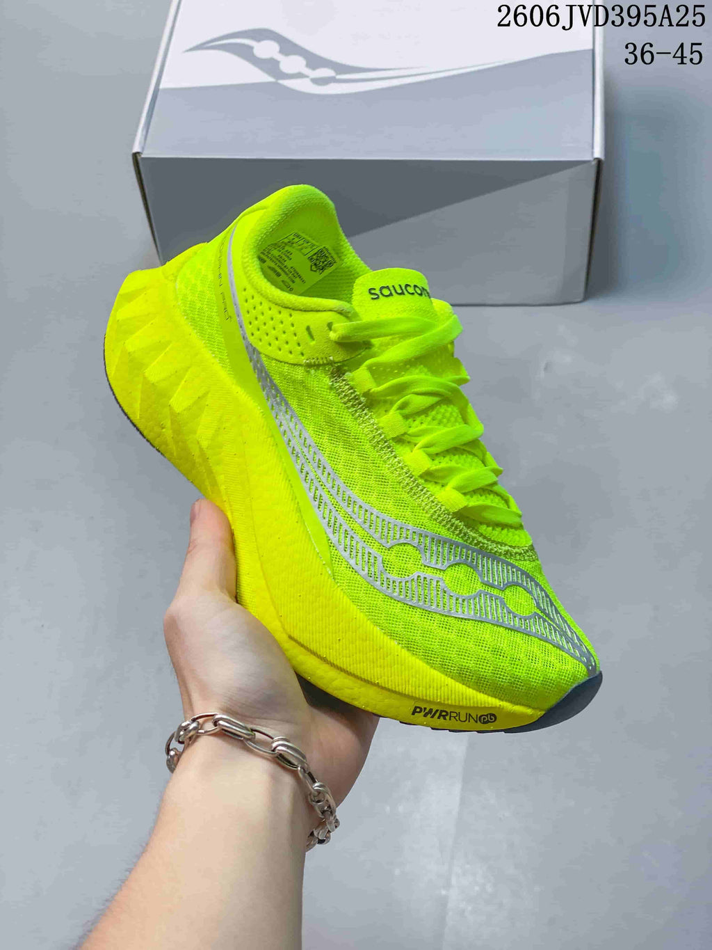 Close-up of a neon yellow Saucony running shoe with silver-gray side details; image text states 36–45.
