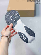 Bottom view of the white running shoe showing black patterned outsole sections and On branding; image text shows 2607JXD1091A21 and 36–45.