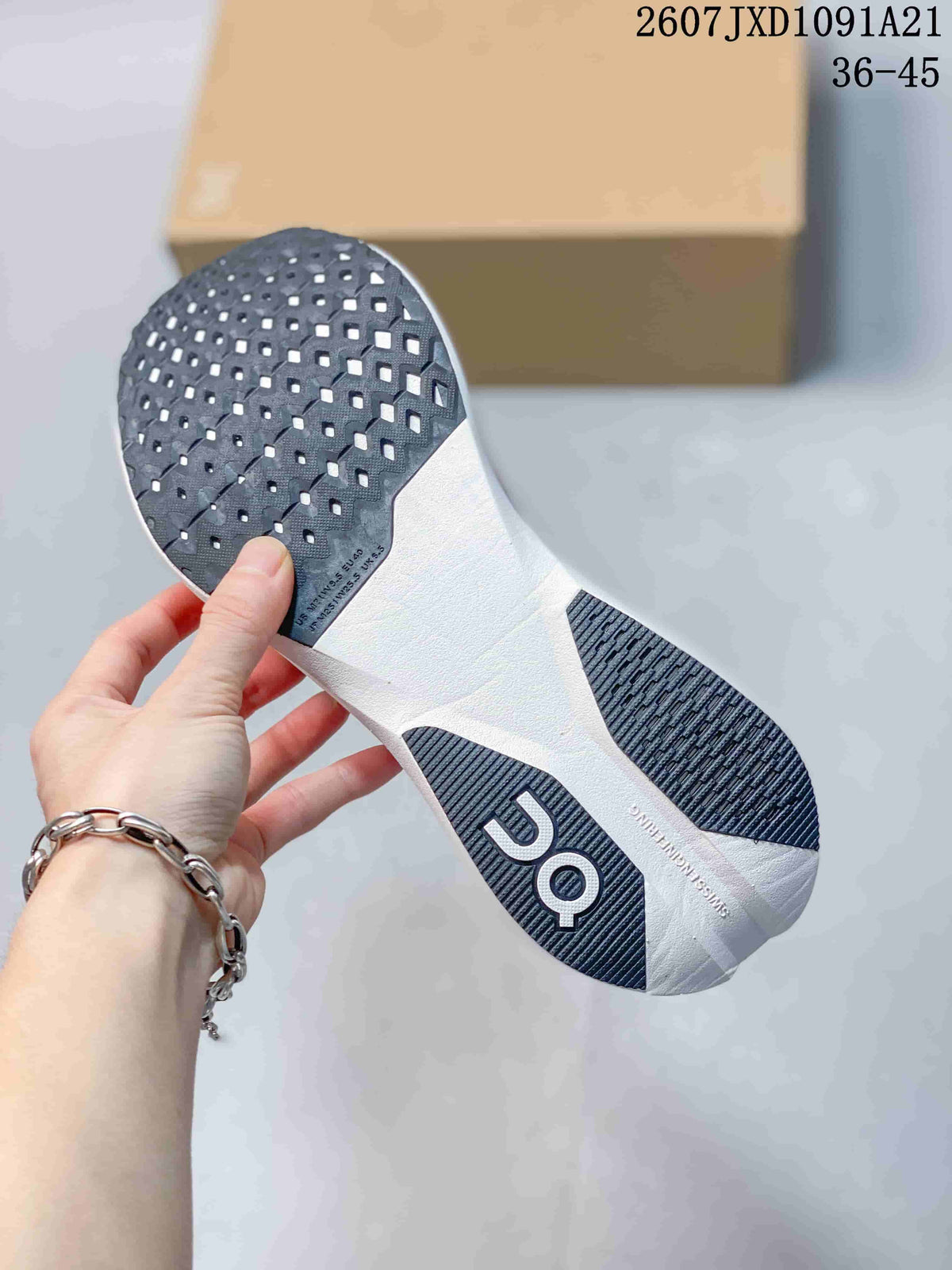Bottom view of the white running shoe showing black patterned outsole sections and On branding; image text shows 2607JXD1091A21 and 36–45.