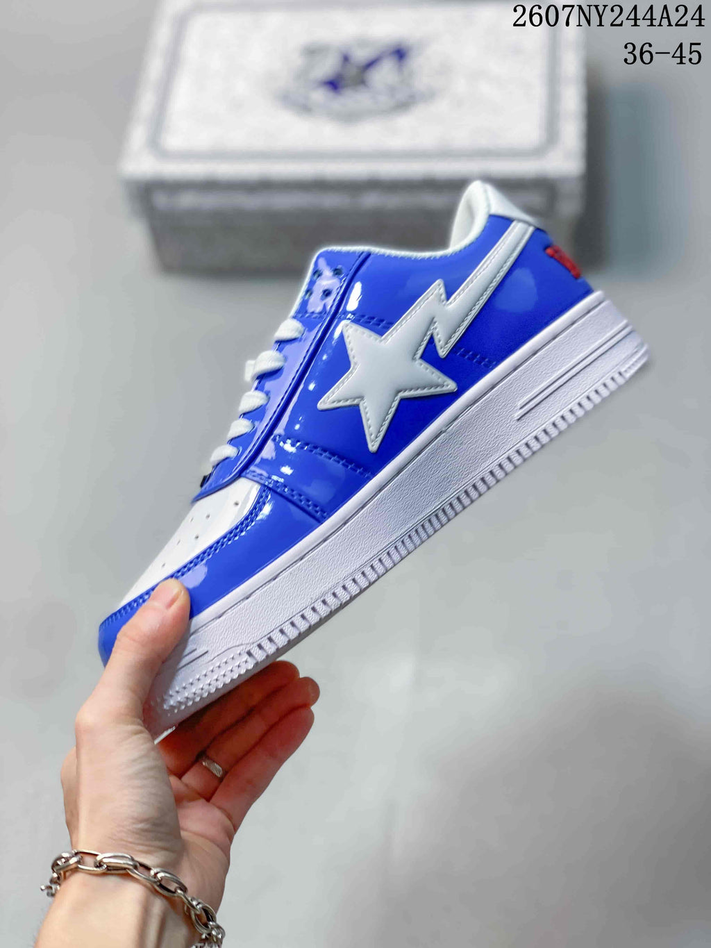 Side view highlighting the glossy blue upper, large white star overlay, and white midsole.