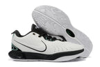 White and black Nike basketball shoe pair with a patterned outsole.