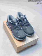 Pair of dark gray On Cloud X 4 sneakers displayed on a shoebox; visible text shows style code 2607JJD1857A17 and size range 36–45.