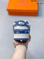 Rear view of the sneaker showing blue patterned heel panels, white midsole, and blue outsole.