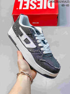 Angled side view of the charcoal sneaker with white laces, side logo, and contrasting sole