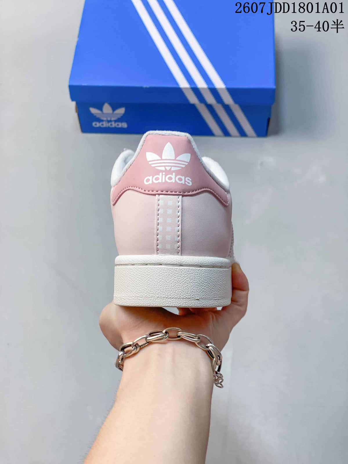 Rear view of the pale pink sneaker with a white sole