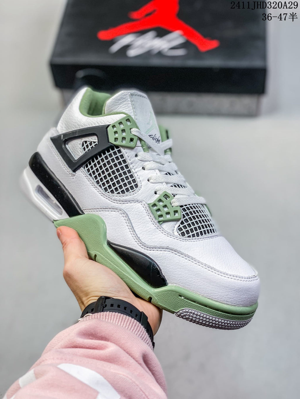 Close-up of a white high-top sneaker with pale green eyelets, side accents, and a green outsole section.