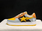 Side profile showing the grey embossed panels, black midsection, yellow star detail, and white midsole.