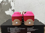 Rear view of red and pink Converse low-top sneakers with tan soles and star-shaped heel details.