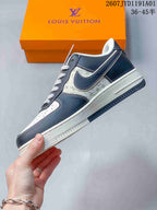 Side profile showing navy overlays, patterned panels, and a white midsole