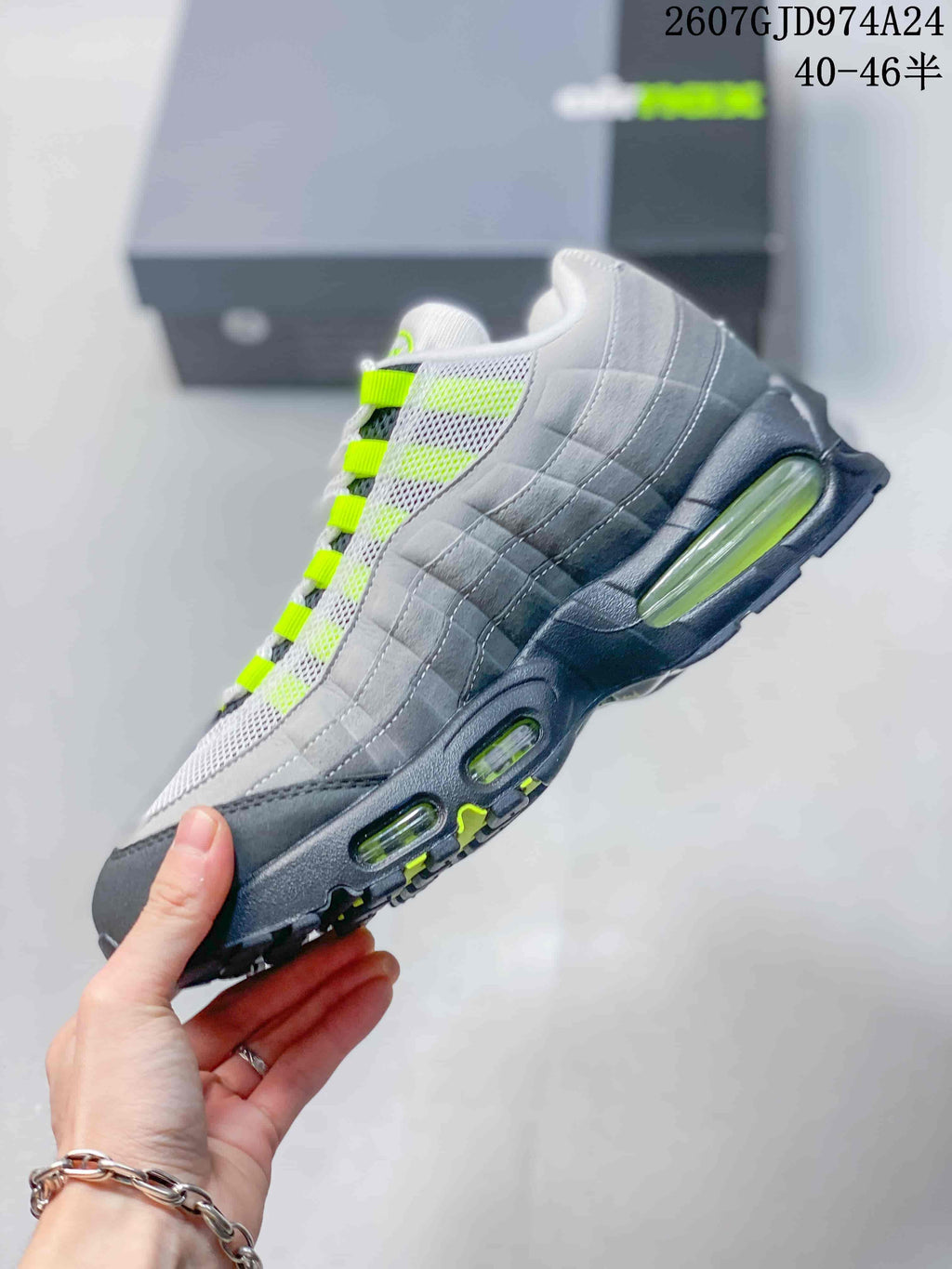 Side profile showing the layered grey upper, mesh panels, neon green accents and multiple visible midsole air windows.