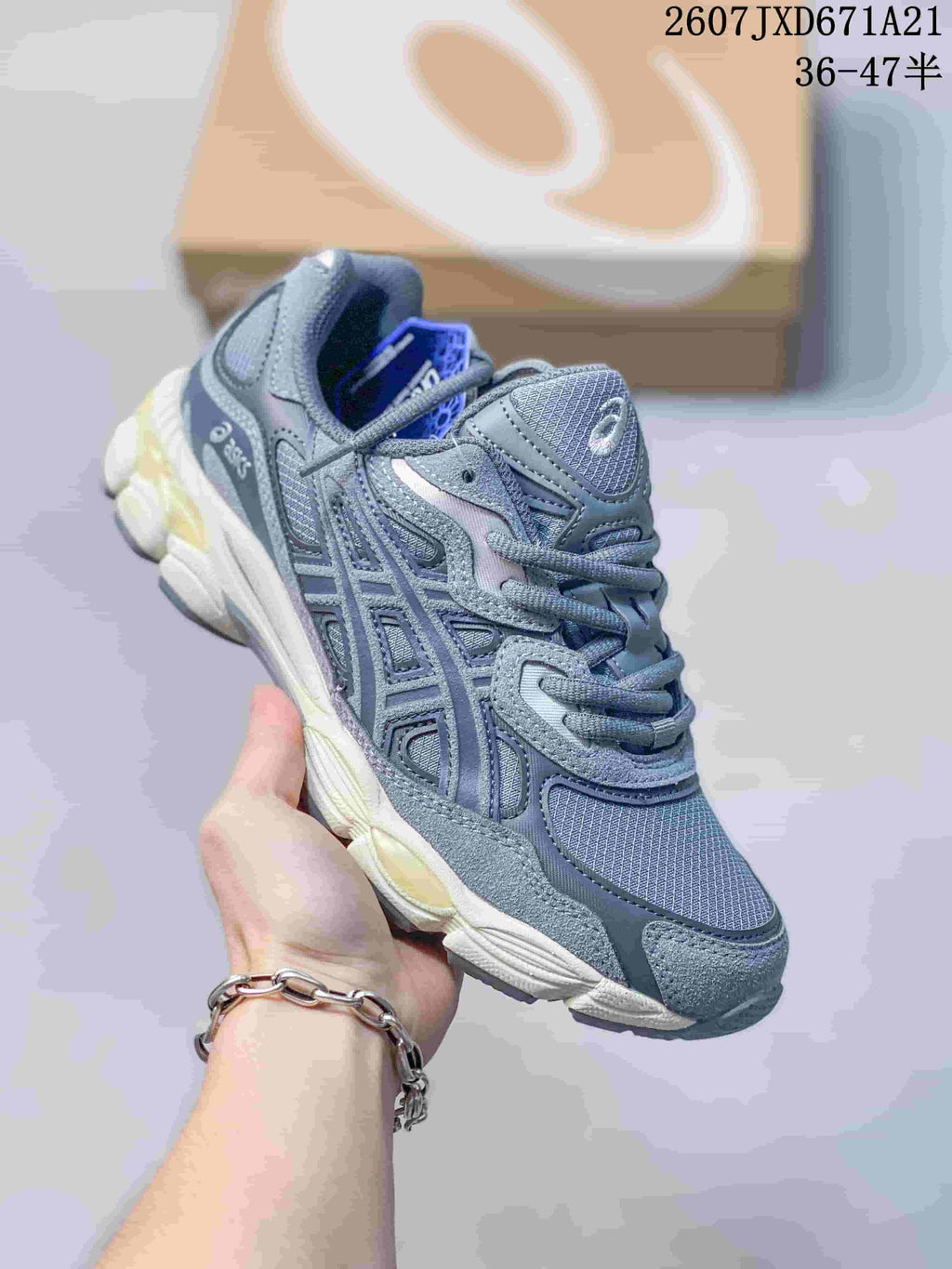 Blue-gray ASICS GEL-Kayano 14 sneaker with a light segmented sole.