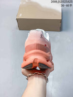 Rear view of the pink and coral sneaker showing the padded collar, heel structure, and segmented outsole.