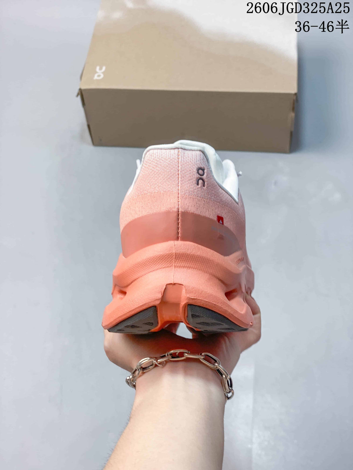 Rear view of the pink and coral sneaker showing the padded collar, heel structure, and segmented outsole.