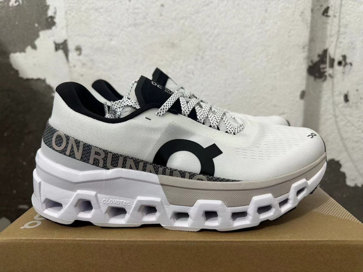 Side view of white On Running sneakers showing gray detailing and sculpted soles