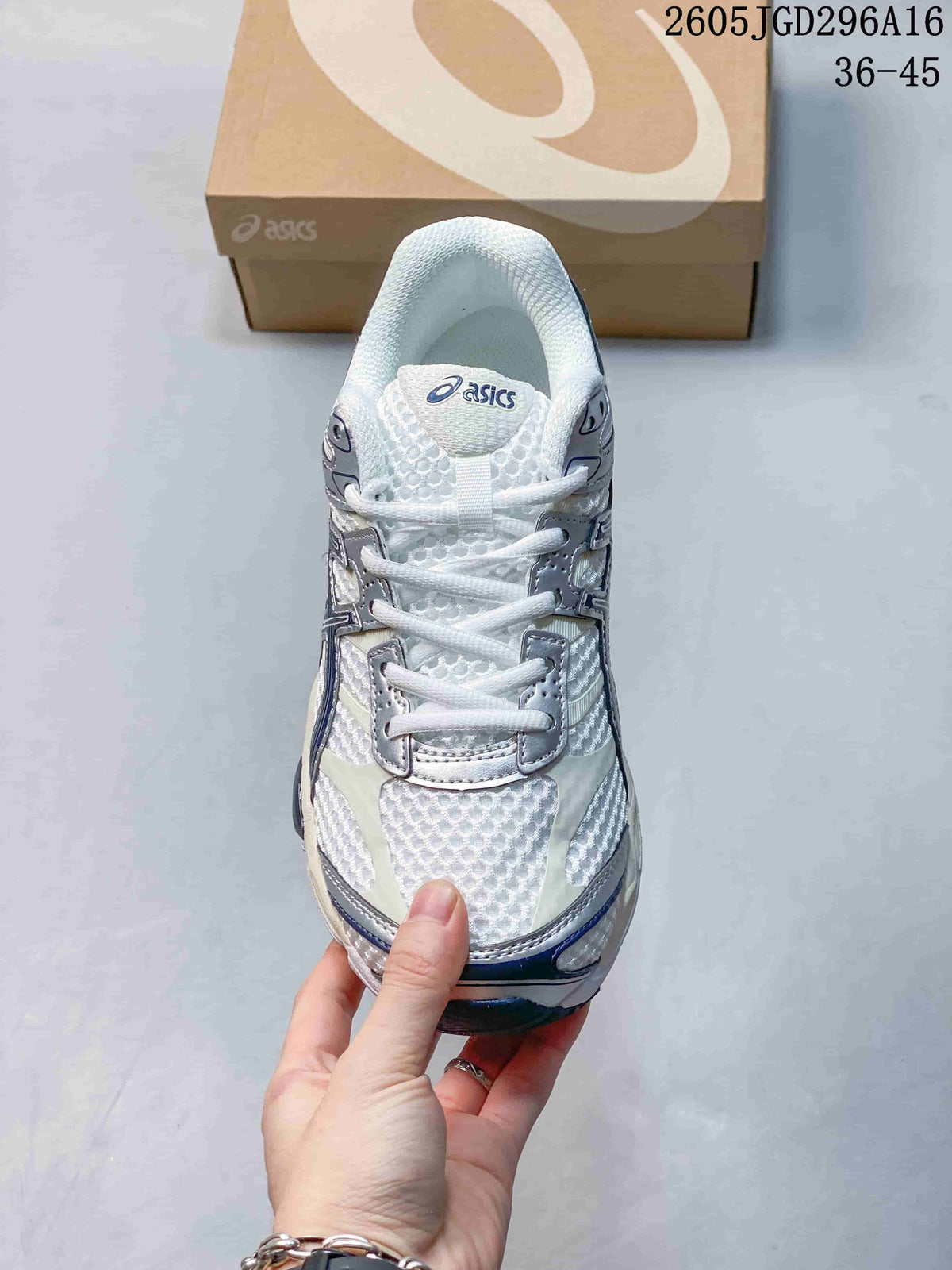 Front view of a white ASICS Gel-Cumulus 16 sneaker with silver details and navy accents.