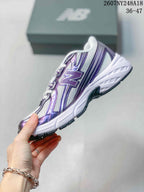 Side profile of a white and purple New Balance 740 sneaker with layered panels and a contrasting outsole.