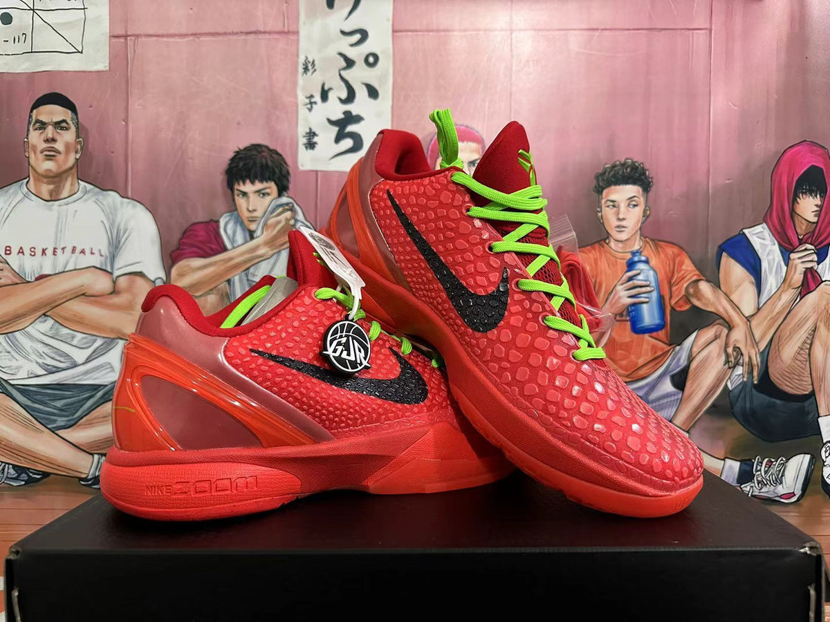 Pair of red basketball shoes shown from the side, with black Swooshes and green laces.