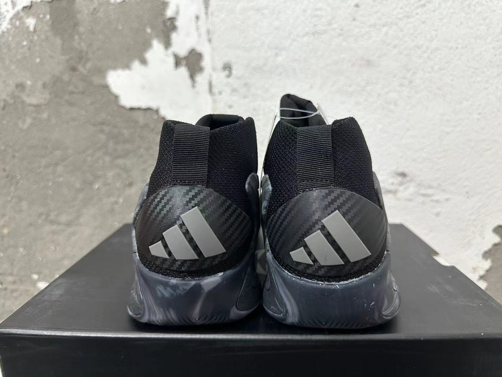 Rear view of black and grey Adidas high-top basketball shoes with three-stripe heel details and marbled grey soles.