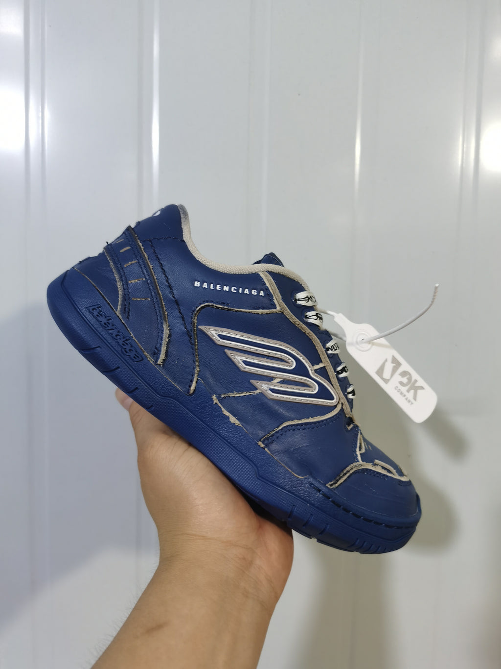 Close angled view of the Balenciaga 4090 sneaker showing the side branding, contrasting trim, and textured outsole.