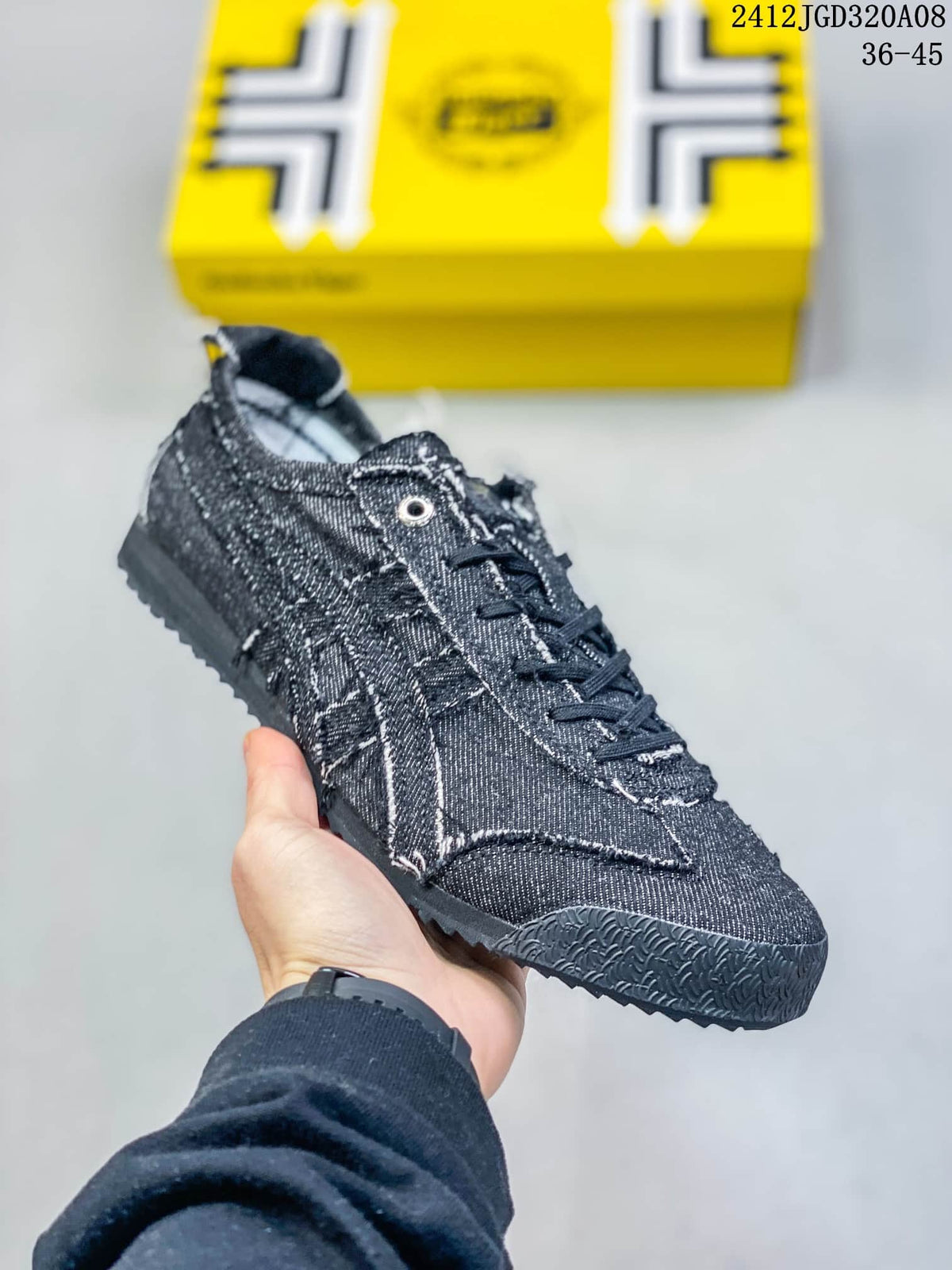 Angled side view of the dark blue low-top sneaker with layered stitched panels and rubber outsole.