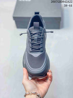 Top view of the dark gray sneaker showing the mesh-textured toe box, padded collar, tongue, and lace system.