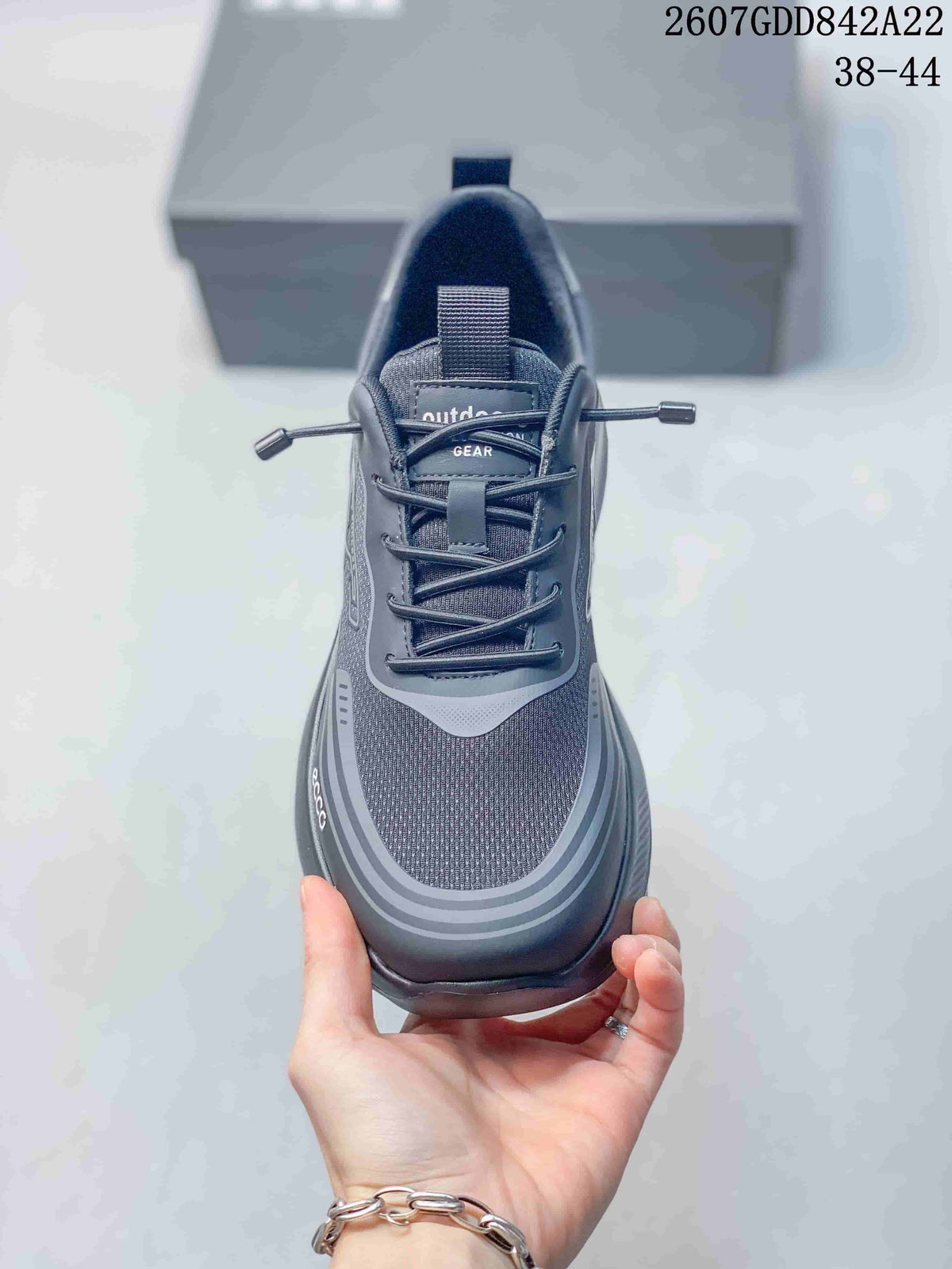 Top view of the dark gray sneaker showing the mesh-textured toe box, padded collar, tongue, and lace system.