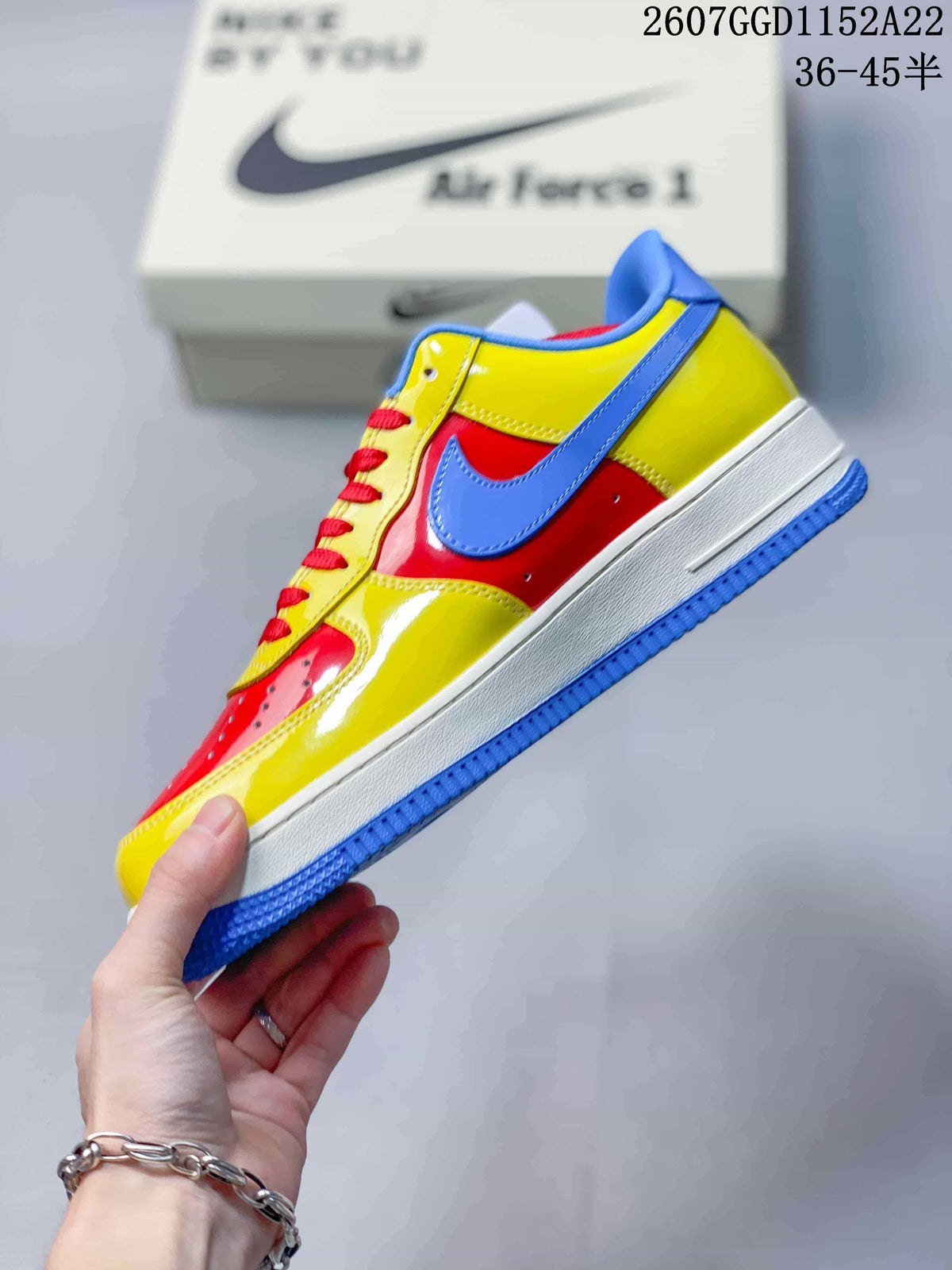 Side view of the sneaker showing the yellow and red upper, blue Swoosh, white midsole, and blue outsole.
