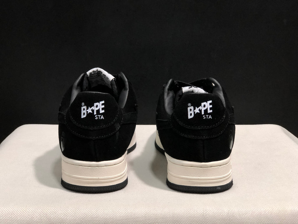 Rear view of the pair showing BAPE STA heel branding and layered white midsoles.