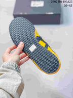 Underside of the sneaker showing a black textured outsole with circular tread details.