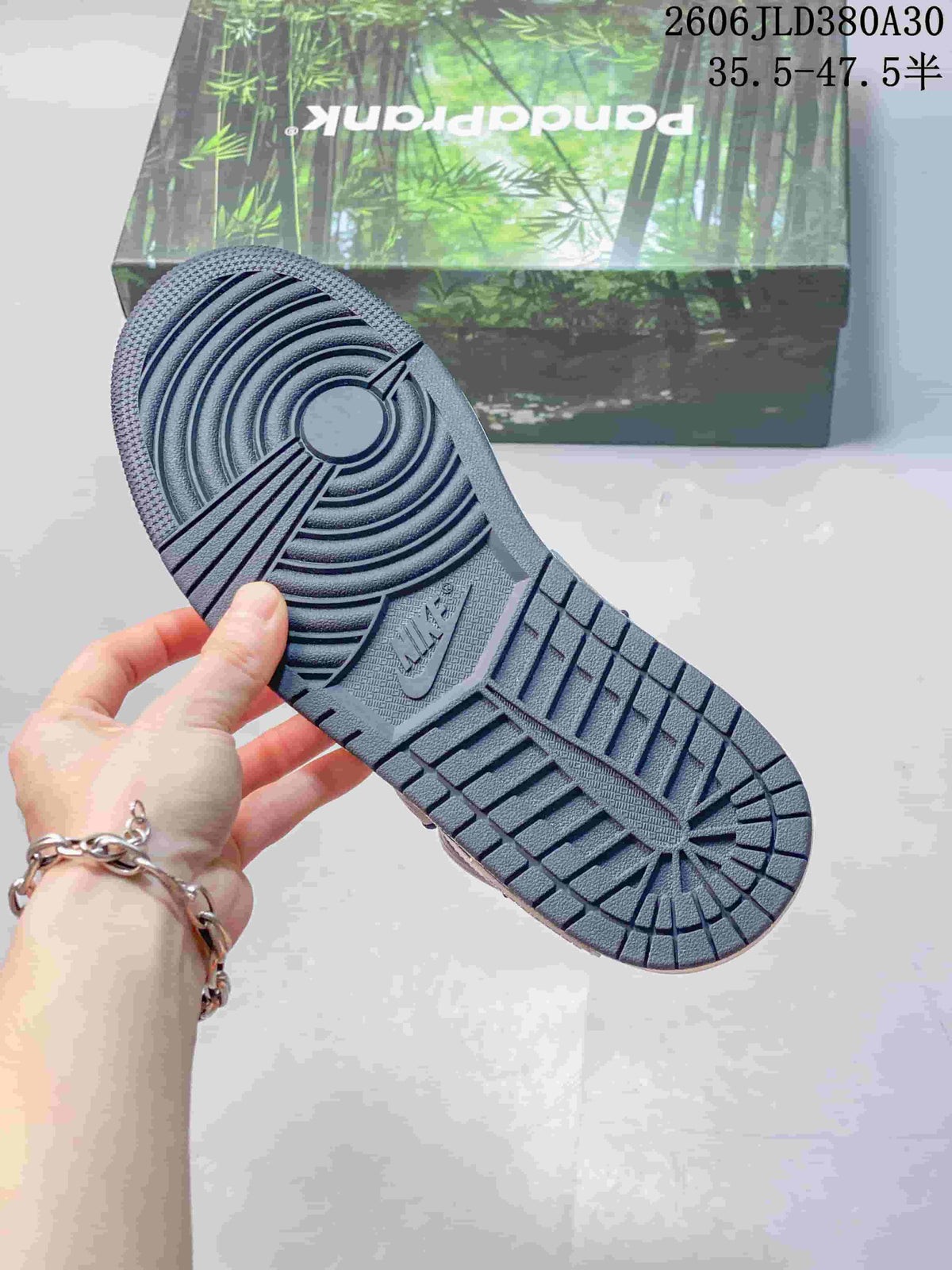 Close-up of the dark outsole showing circular and linear tread patterns.