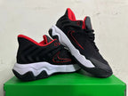 Pair of black and red basketball shoes shown from the side, with sculpted white midsoles.