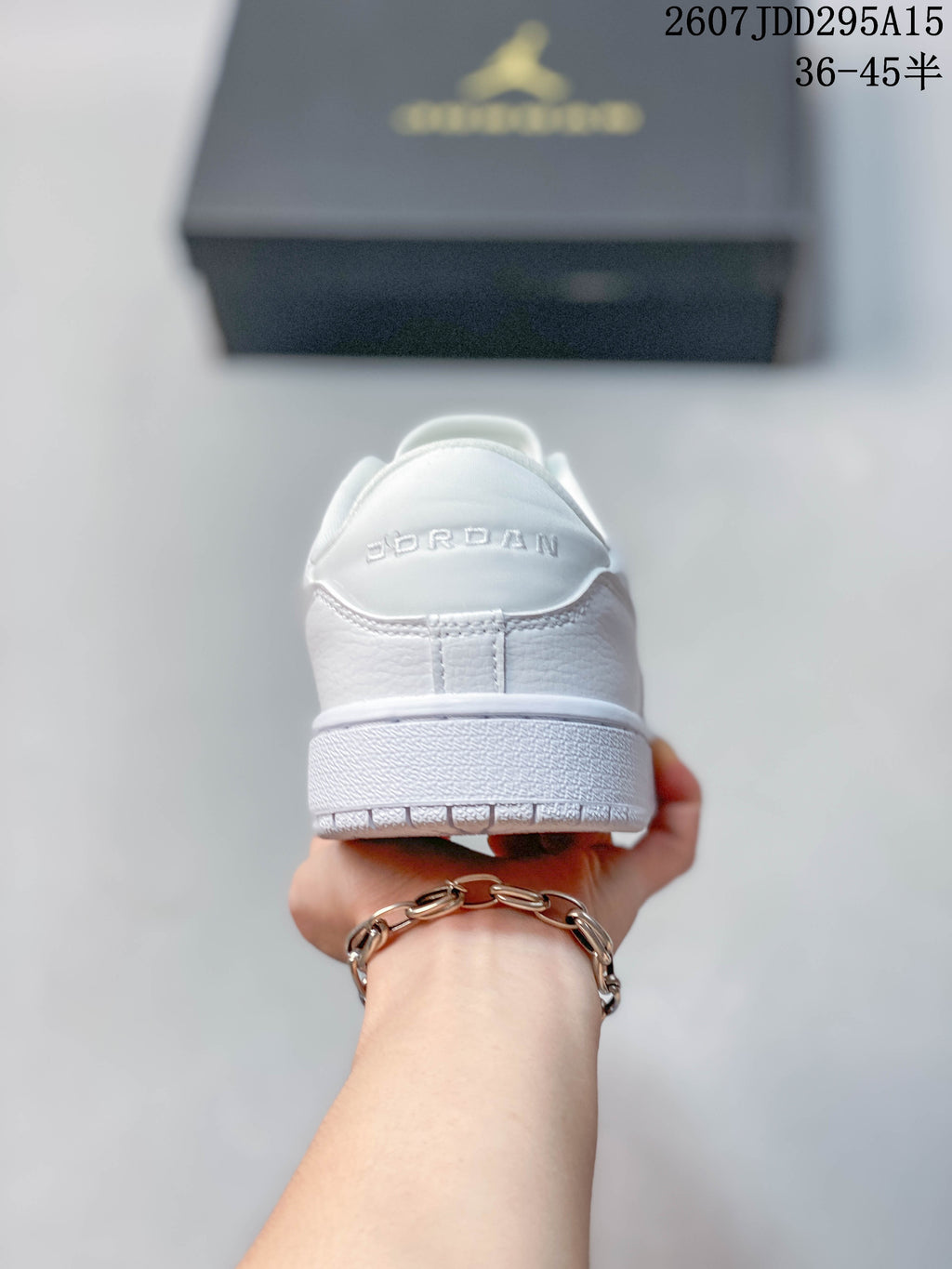 Rear view of the white sneaker showing Jordan branding on the heel and the layered outsole.