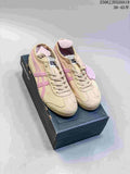 Pair of beige and pink Onitsuka Tiger low-top sneakers displayed on a shoebox.