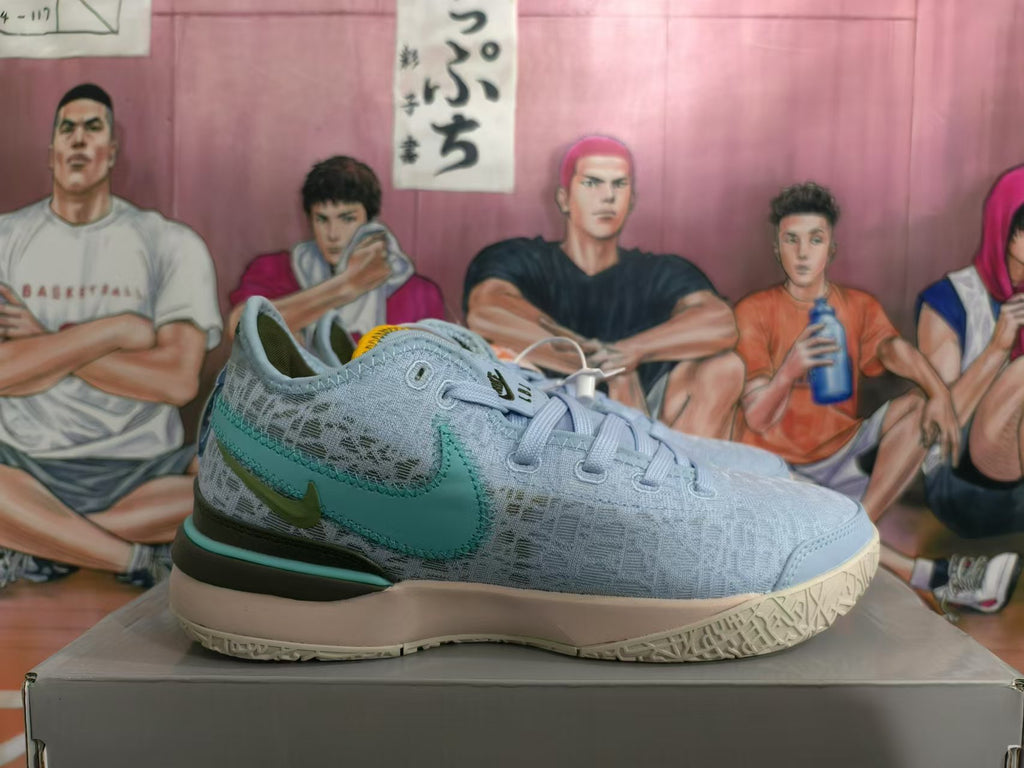 Side view of a light blue Nike basketball shoe with a teal side logo and dark olive heel panel