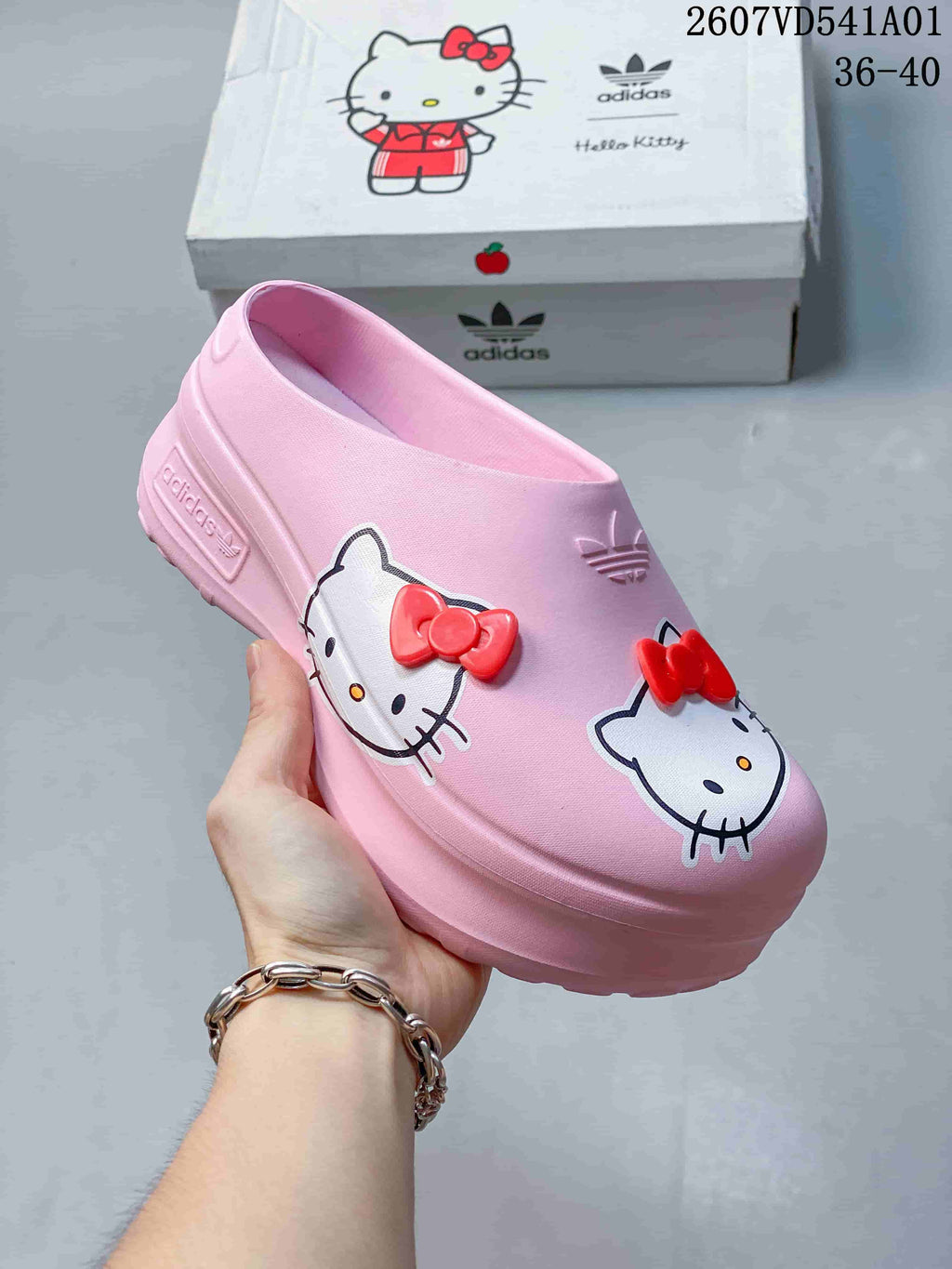 Pink Hello Kitty platform mule clog shown close up from the side.