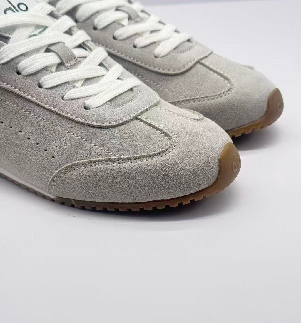 Close-up of the stitched toe panels, white laces, and gum-colored toe and outsole edge.