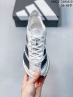 Top view of the white and dark navy lace-up sneaker with Adidas branding on the tongue and toe.