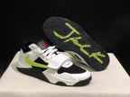 Sneaker outsole view showing the black textured tread and fluorescent green graphic detail.