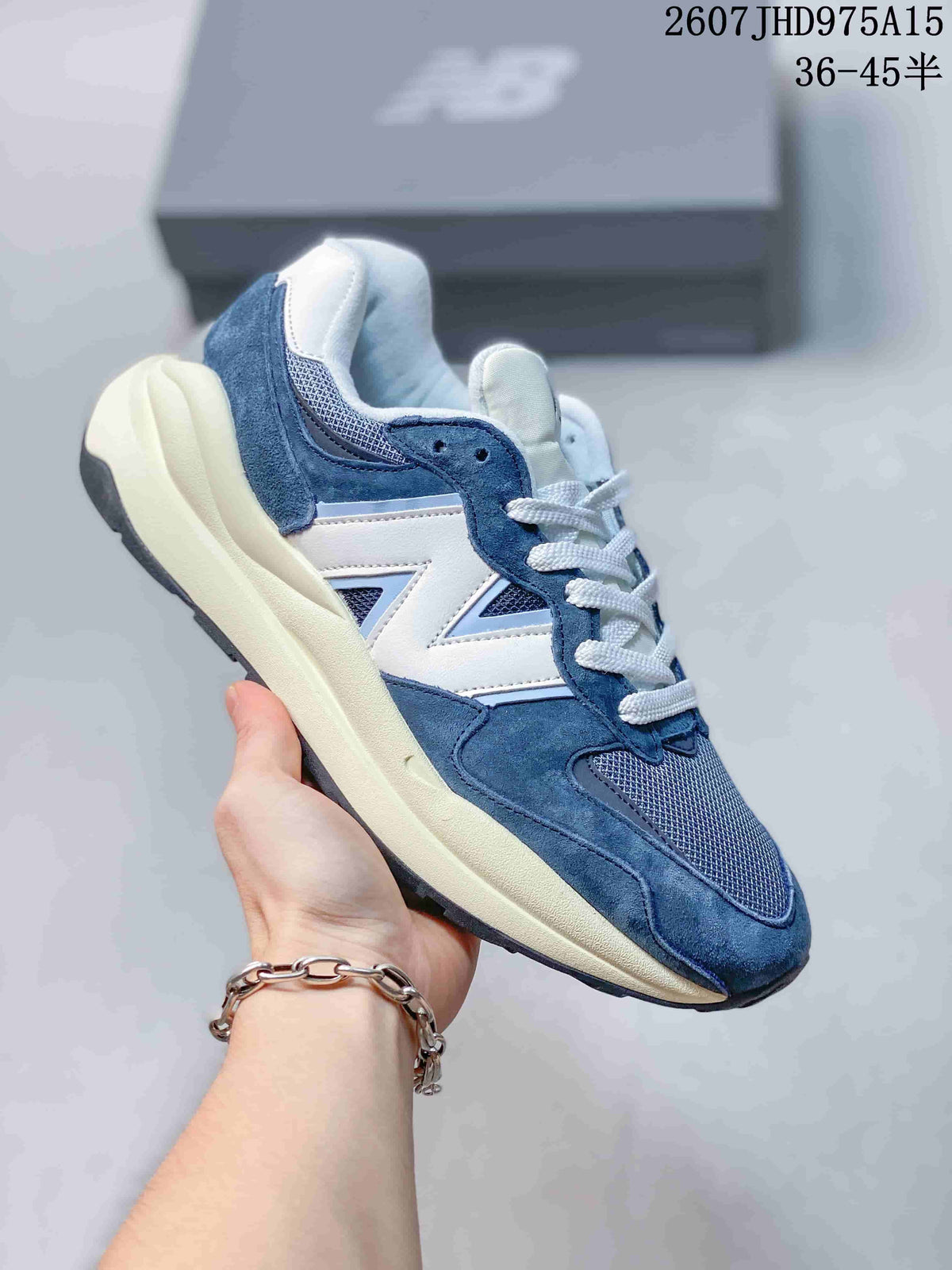 Blue and white New Balance 5740 sneaker showing the side logo and sculpted midsole.