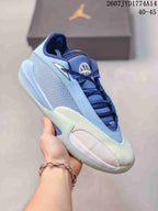 Side view of a blue and pale green Jordan Triangle basketball shoe with a mesh side panel and padded collar.