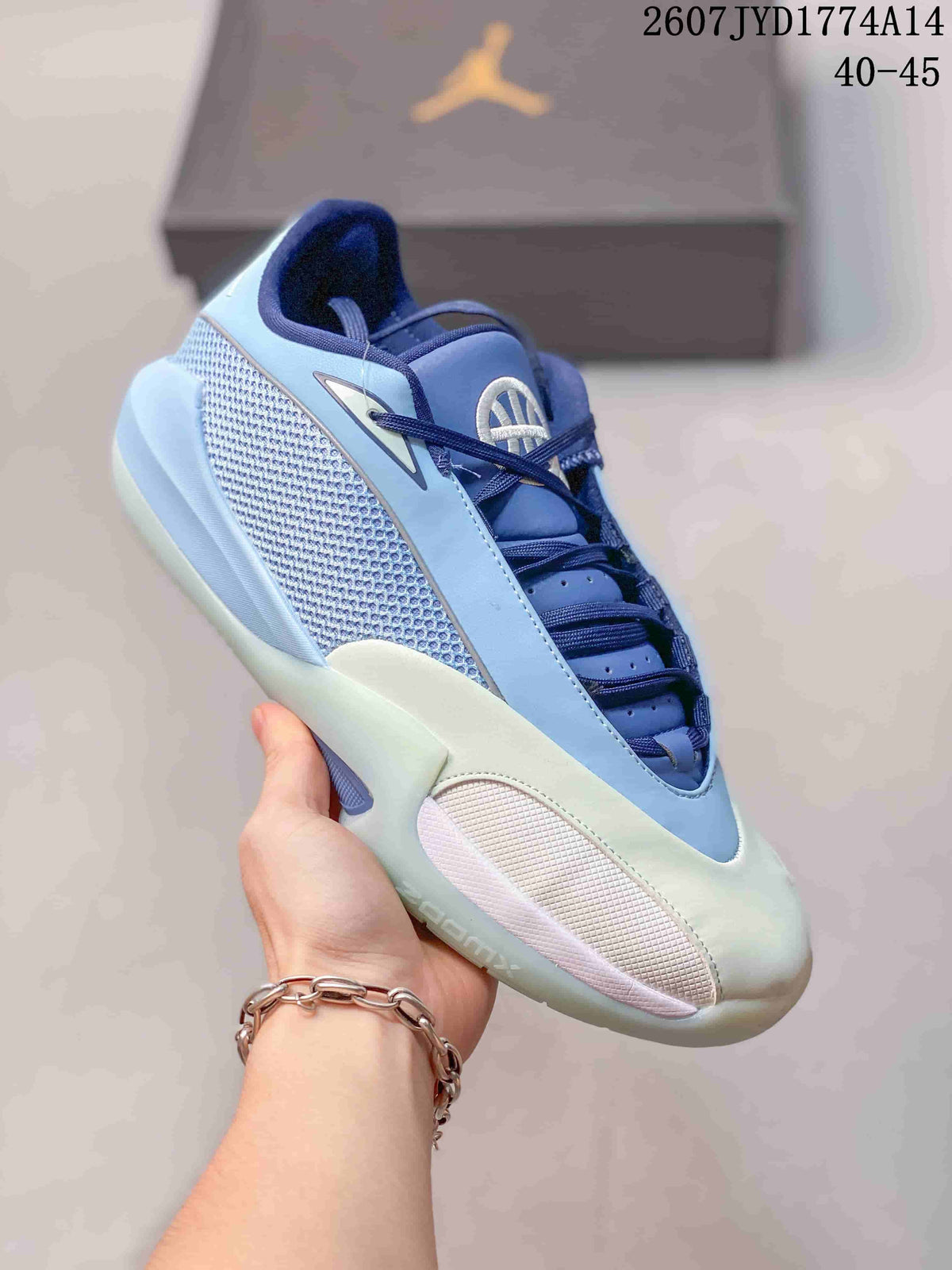 Side view of a blue and pale green Jordan Triangle basketball shoe with a mesh side panel and padded collar.