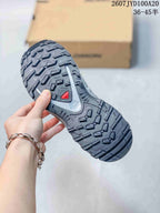 Close-up of the lugged outsole showing the tread pattern and red outsole detail.