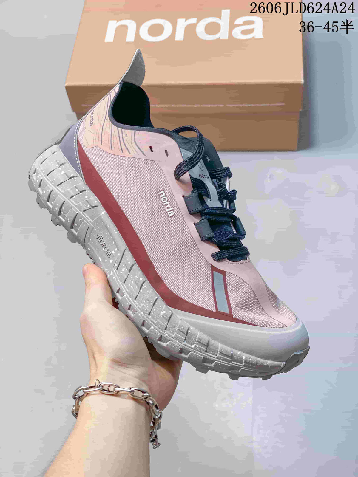 Angled side view of the pink and gray shoe with a rugged outsole